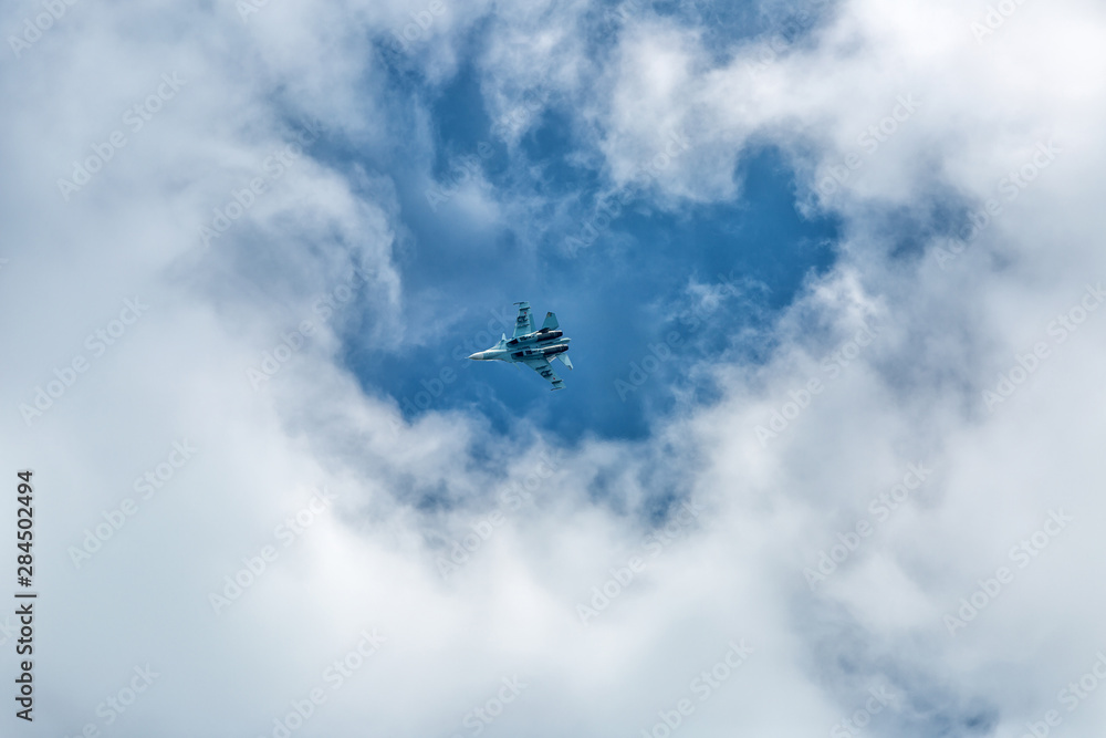 War jet plane among cloudscape