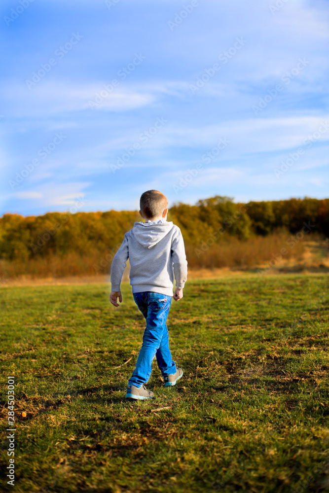 young man running on green field young man running on green field