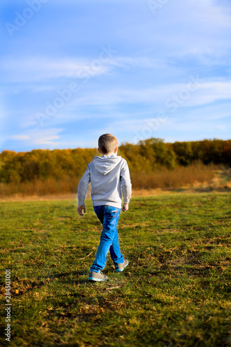 young man running on green field