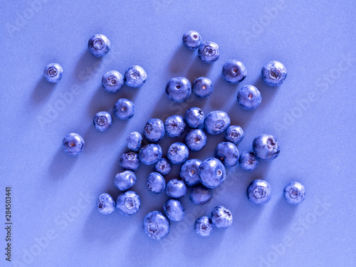 blueberry berry on a blue background. summer and vitamins