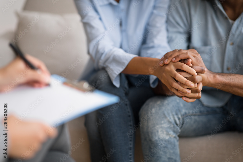 Black Husband And Wife Holding Hands At Marital Psychologist's Office Black Husband And Wife Holding Hands At Marital Psychologist's Office