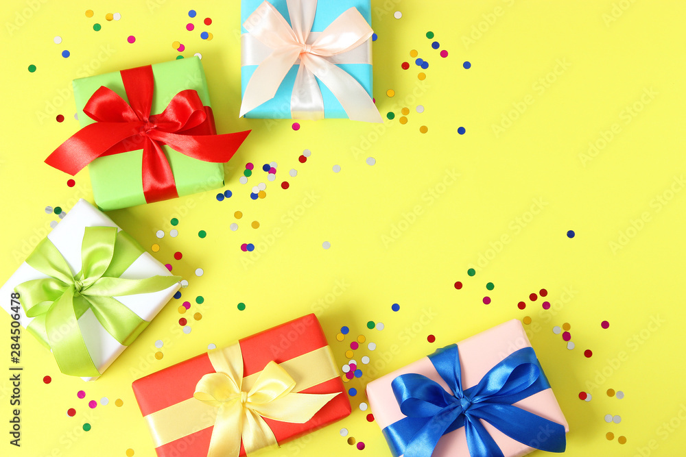 gifts and confetti on a colored background top view. Holiday giving gifts gifts and confetti on a colored background top view. Holiday giving gifts