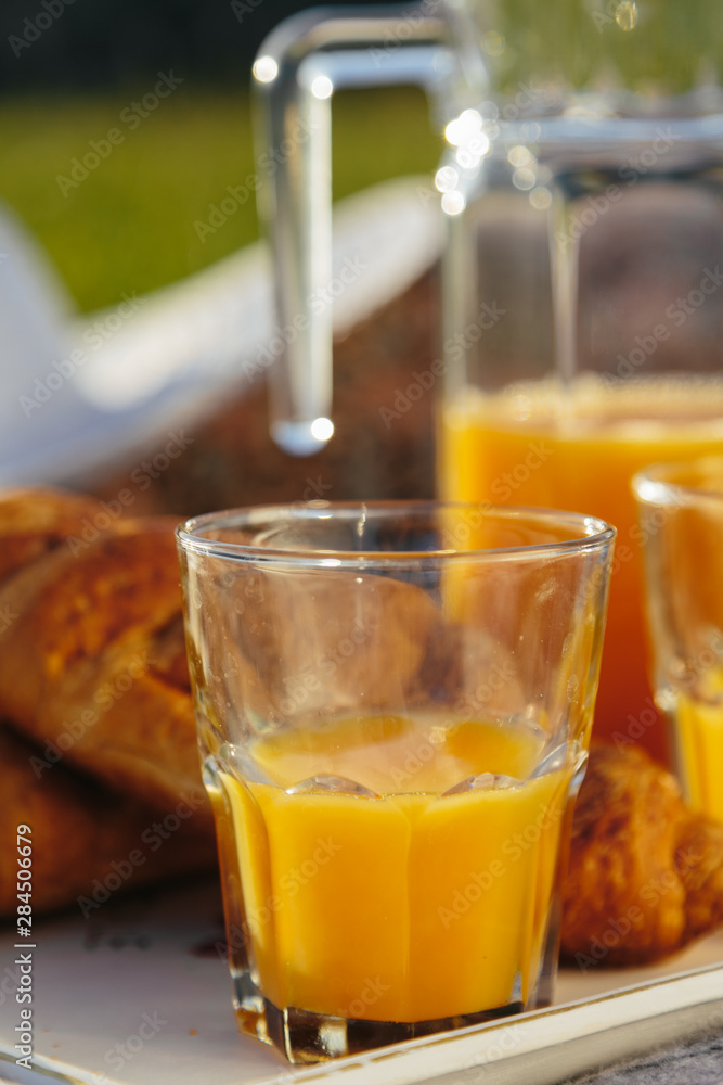 fresh orange and croissant, a picnic in nature fresh orange and croissant, a picnic in nature