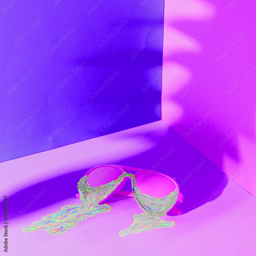 Iridescent shimmering liquid dripping from colored fashionable sunglasses in ultraviolet. Iridescent shimmering liquid dripping from colored fashionable sunglasses in ultraviolet.