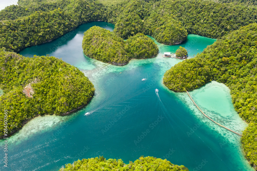 Cove and blue lagoon among small islands covered with rainforest. Sugba lagoon, Siargao, Philippines. Aerial view of Sugba lagoon, Siargao,Philippines.
