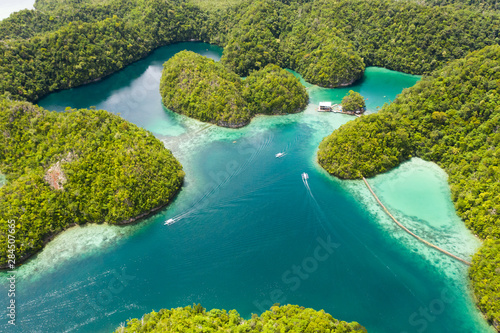 Cove and blue lagoon among small islands covered with rainforest. Sugba lagoon  Siargao  Philippines. Aerial view of Sugba lagoon  Siargao Philippines.