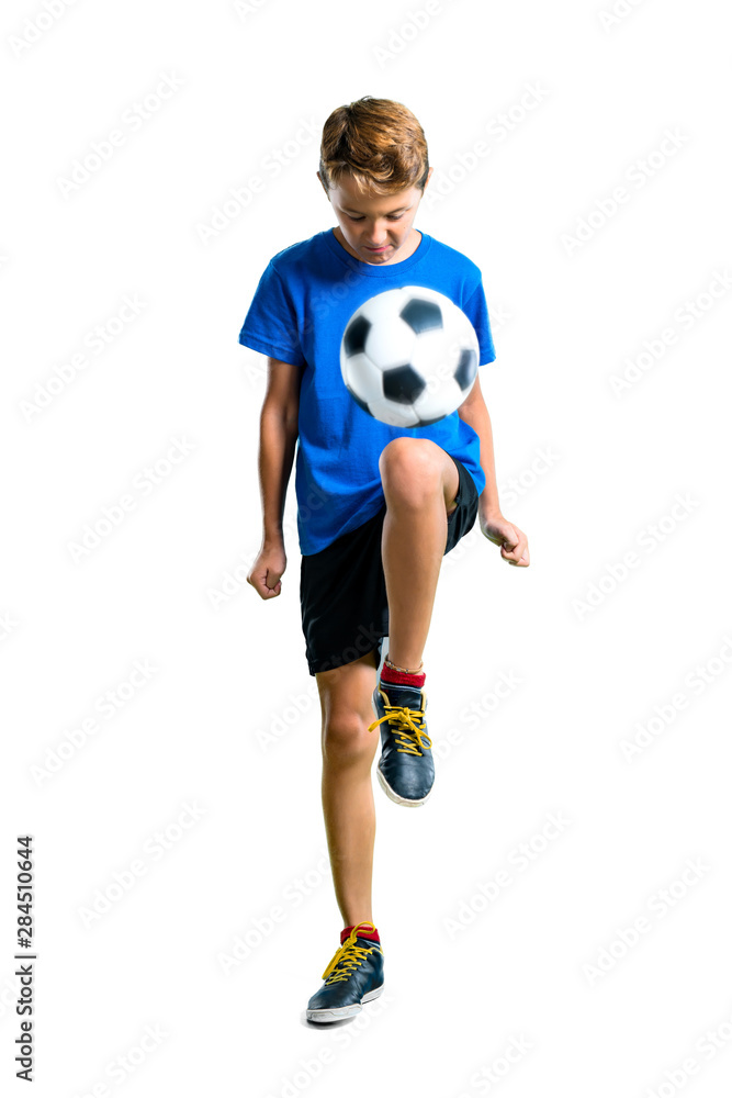 A full-length shot of Boy playing soccer on isolated white background