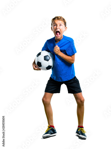 A full-length shot of Lucky boy playing soccer on isolated white background