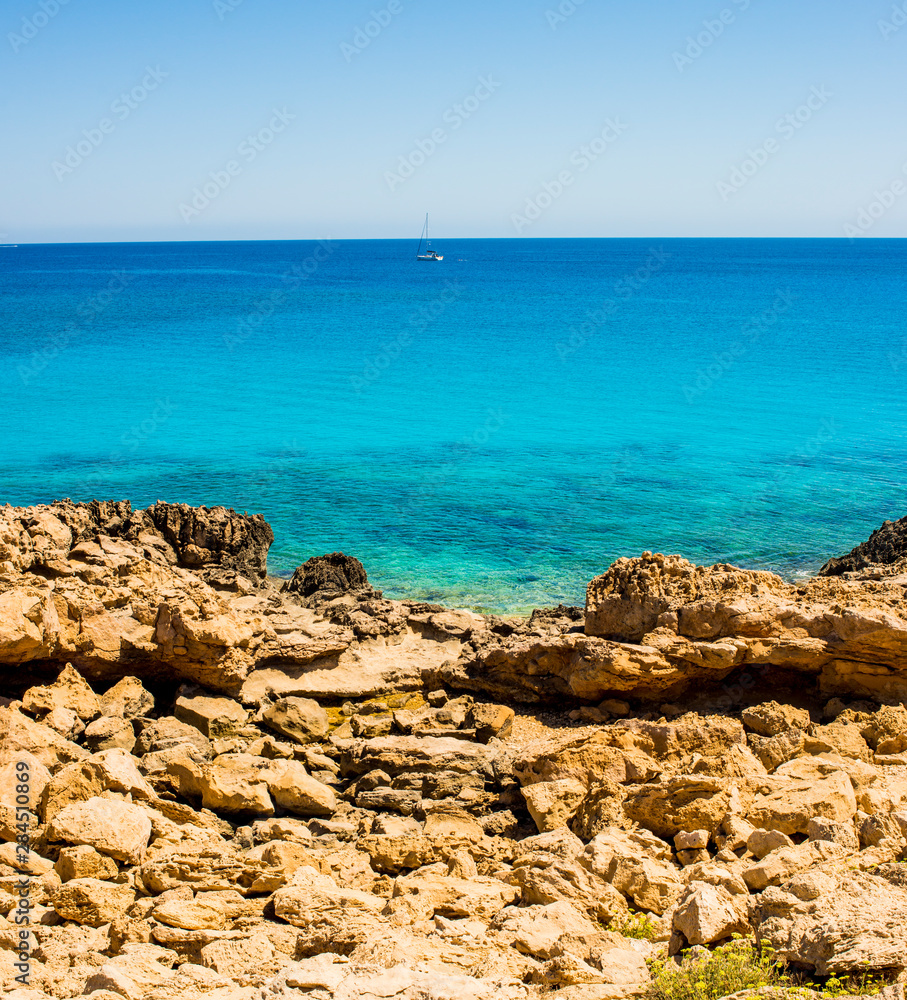 colorful pristine nature of the coast of Cyprus cape cavo greco with clear blue water and yellow rocks colorful pristine nature of the coast of Cyprus cape cavo greco with clear blue water and yellow rocks