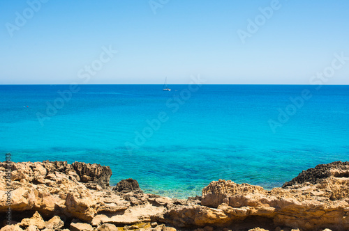  colorful pristine nature of the coast of Cyprus cape cavo greco with clear blue water and yellow rocks