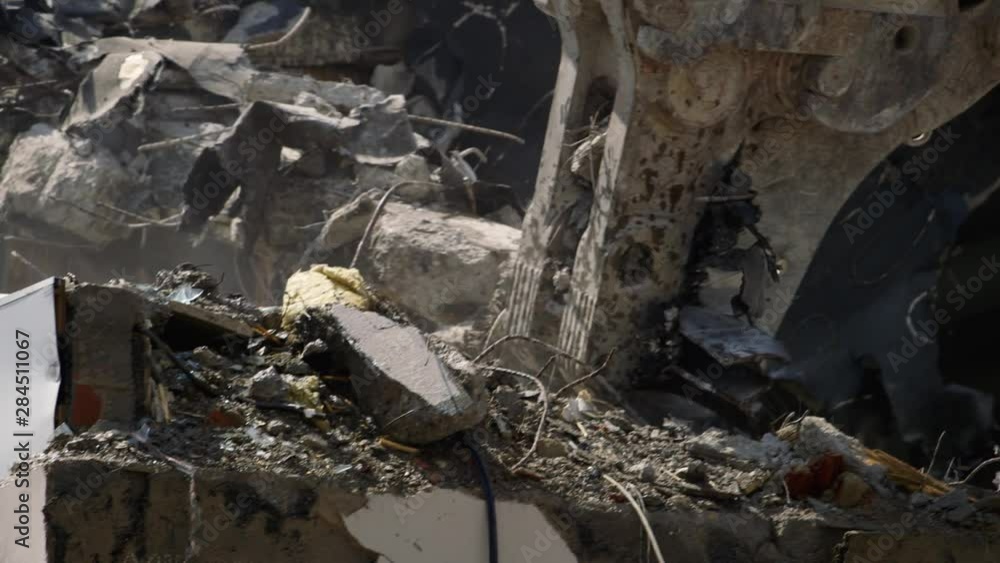 Close up of a cutting machine tearing down a roof of a condemned building Close up of a cutting machine tearing down a roof of a condemned building