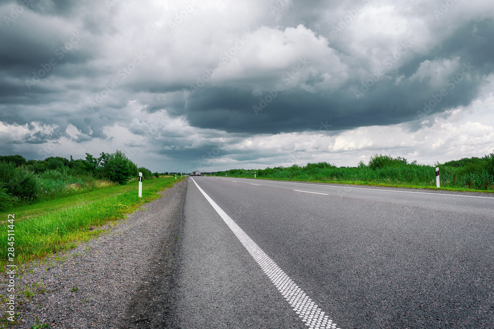 Highway going to the horizon. Beautiful cloudy sky. Travel Background.