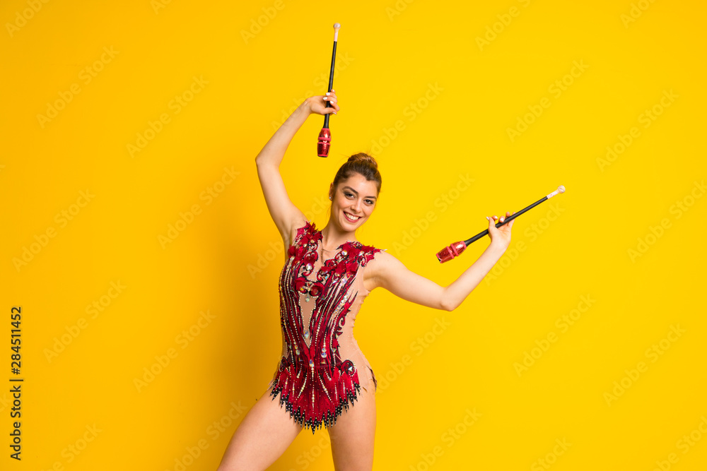 Girl doing rhythmic gymnastics with maces. Girl doing rhythmic gymnastics with maces.