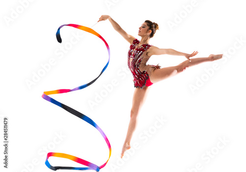 Fototapeta Naklejka Na Ścianę i Meble -  Girl doing rhythmic gymnastics with ribbon . jumping