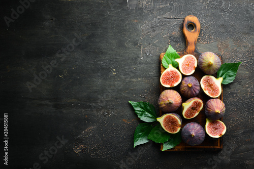 Figs on wooden background. Tropical fruits. Top view. Free copy space.
