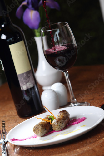 Grilled sausages accompanied by red wine.