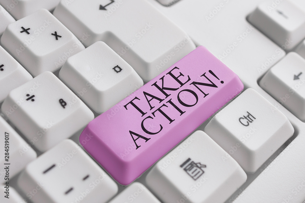 Conceptual hand writing showing Take Action. Concept meaning do something official or concerted to achieve aim with problem White pc keyboard with note paper above the white background