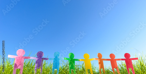 a colorful people chain made of paper, green and ecology concept