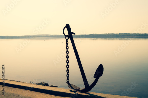 Anchor on the shore. anchor stands on the pier