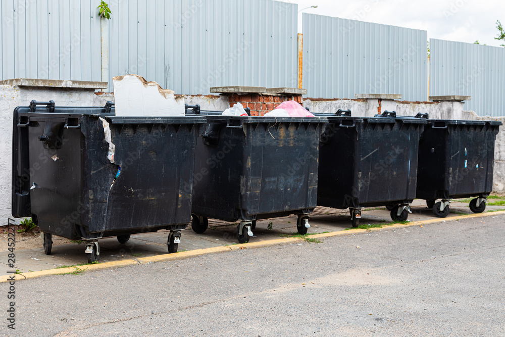 Black trash containers on street, environmental pollution Black trash containers on street, environmental pollution