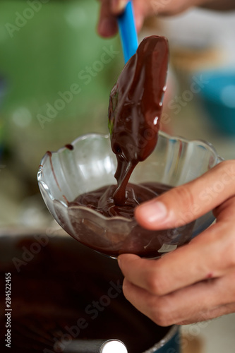 Preparing homemade chocolate pudding, closeup on hands