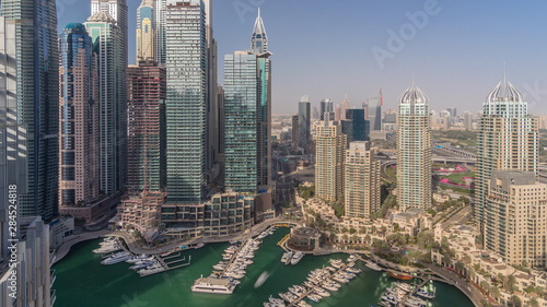 Fototapeta Naklejka Na Ścianę i Meble -  Aerial top view of Dubai Marina morning timelapse. Modern towers and traffic on the road