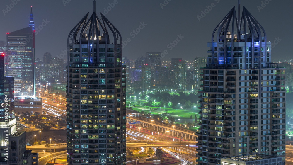 Naklejka premium Aerial top view of Dubai Marina night timelapse. Modern towers and traffic on the road