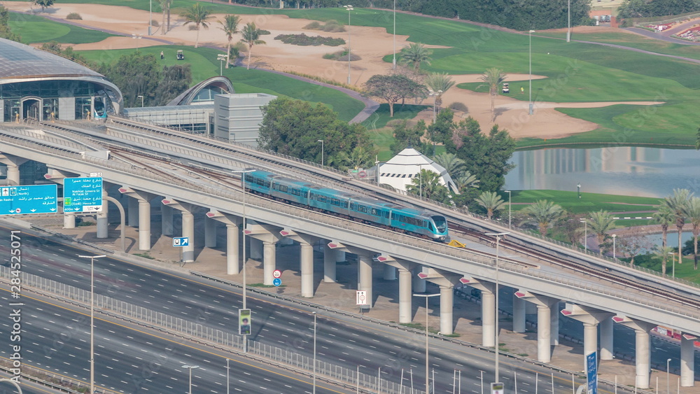 Naklejka premium Metro station services both the Dubai Internet City and Dubai Media City districts of Dubai, as well as Golf Club timelapse