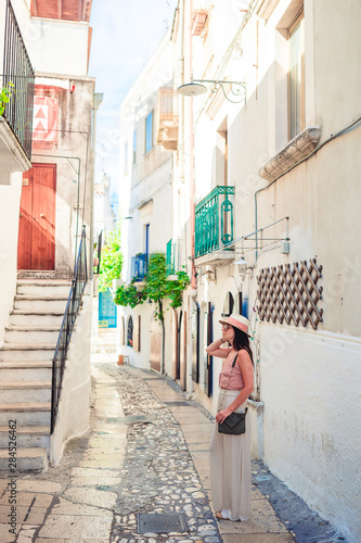 Girl tourist walks outdoors in narrow street © travnikovstudio
