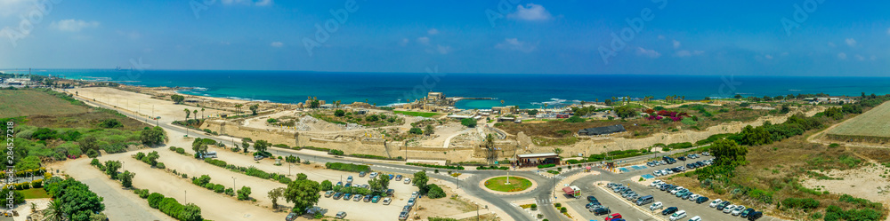 Aerial panoramic view of the ruins of the Roman, Byzantine, Crusader era fortified town in Caesarea Maritima built originally by Herod the Great in Israel 