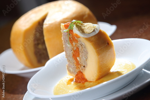 Edam cheese stuffed with beef stew with tomato sauce and hard-boiled egg.