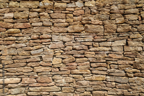 Old castle stone wall texture background. Part. Sand color, natural stone. Design.