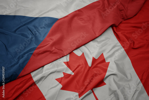 waving colorful flag of canada and national flag of czech republic.