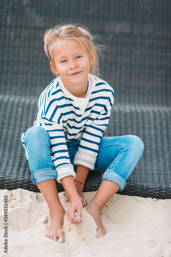 Fototapeta premium Beautiful little girl at beach having fun. Funny girl enjoy summer vacation.