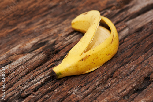 Peeled banana on wooden background