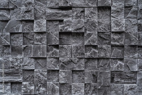 Background from dark square granite. Artificial stone for granite.