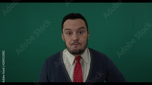 Dishonest political deputy talking words on camera trying to mislead standing against green background. Shot with green screen background photo