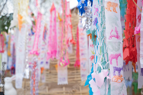 Prayer flags tung Hang with umbrella or Northern traditional flag hang on sand pagoda in the temple for Songkran Festival is celebrated in a traditional New Year's Day in Chiang Mai,Thailand.