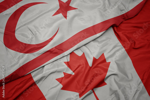 waving colorful flag of canada and national flag of northern cyprus.