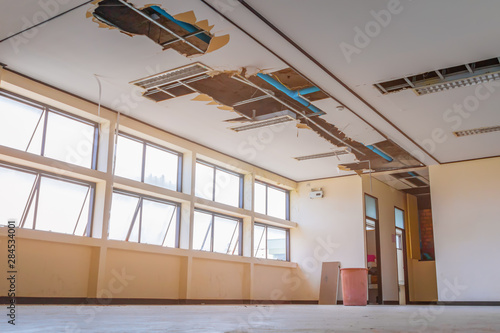 repair leak water pipe in under gypsum ceiling interior office building and bucket water