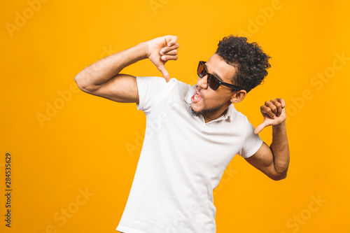 Cool afro american man wearing sunglasses over isolated background, having successful idea. Exited and happy. Number one. Thumbs up.