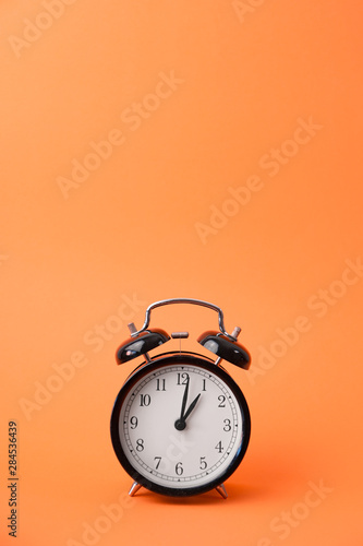 vintage alarm clock on a orange background