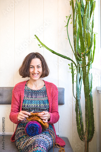 The woman is crocheting. photo