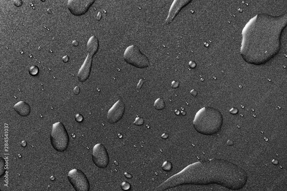 Water drops on the black surface Water drops on the black surface