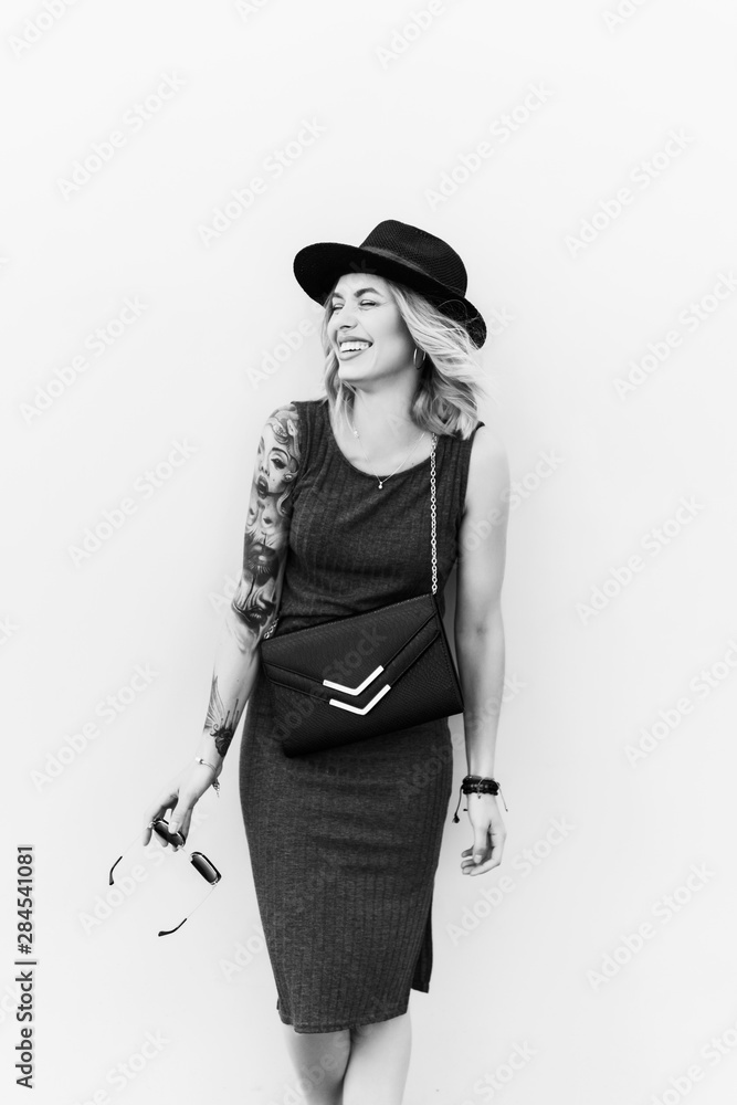 emotional portrait of Fashion stylish portrait of pretty young hipster blonde woman,going crazy,elegant black hat,soft colors,cool crazy girl.Red urban wall background.surprised girl close up, sunset emotional portrait of Fashion stylish portrait of pretty young hipster blonde woman,going crazy,elegant black hat,soft colors,cool crazy girl.Red urban wall background.surprised girl close up, sunset