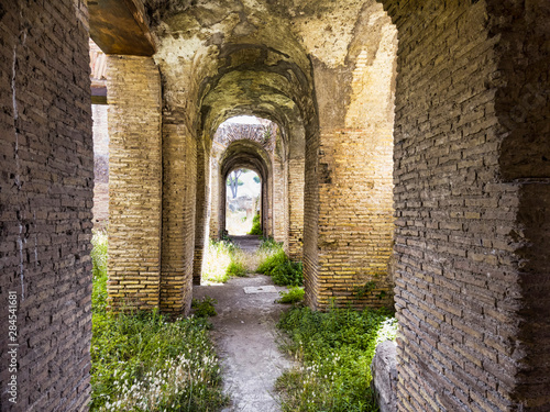 Corridors of the ancient Roman buildings in the archaeological excavations of Ostia Antica  arches and ceilings with stuccoes and well preserved decorations