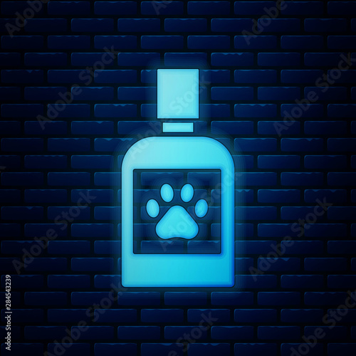 Glowing neon Dog medicine bottle icon isolated on brick wall background. Container with pills. Prescription medicine for animal. Vector Illustration