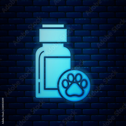 Glowing neon Dog medicine bottle icon isolated on brick wall background. Container with pills. Prescription medicine for animal. Vector Illustration