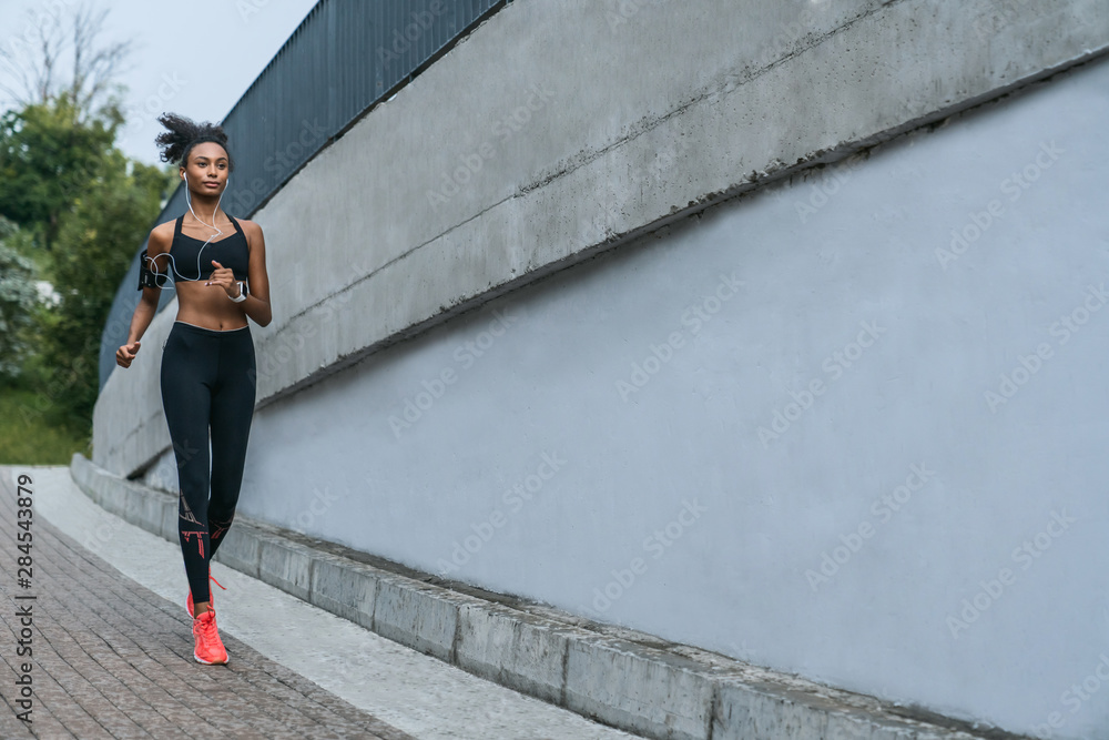Full length view shot female sportswoman exercising in morning outdoors Full length view shot female sportswoman exercising in morning outdoors