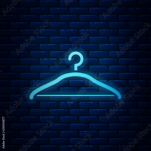 Glowing neon Hanger wardrobe icon isolated on brick wall background. Cloakroom icon. Clothes service symbol. Laundry hanger sign. Vector Illustration